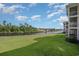 Expansive backyard featuring lush green lawn leading to the waterfront at 619 Waterway Village Blvd. # 7C, Myrtle Beach, SC 29579