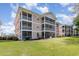 Exterior of a multi-story building with private screened patios and green spaces at 619 Waterway Village Blvd. # 7C, Myrtle Beach, SC 29579