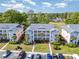 An inviting view of a condo building, with lush landscaping, golf course, parking area and well-maintained lawns at 619 Waterway Village Blvd. # 7C, Myrtle Beach, SC 29579