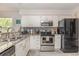 Contemporary kitchen features granite countertops, stainless steel appliances, and modern white cabinetry at 619 Waterway Village Blvd. # 7C, Myrtle Beach, SC 29579