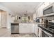 An open kitchen with granite countertops, stainless steel appliances, white cabinetry, and a view to the living room at 619 Waterway Village Blvd. # 7C, Myrtle Beach, SC 29579