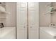 A clean and compact laundry room with white bi-fold doors, washer, dryer, and shelving for storage at 619 Waterway Village Blvd. # 7C, Myrtle Beach, SC 29579