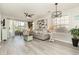 Bright living room with sliding glass doors leading to a patio, modern ceiling fan, and wood-look flooring at 619 Waterway Village Blvd. # 7C, Myrtle Beach, SC 29579