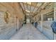 Rustic barn interior featuring wooden stalls with metal bars, concrete flooring, and ample lighting at 6200 Adrian Pkwy., Conway, SC 29526