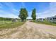Scenic drive leading to a ranch with mature trees and a sign for The Thurlo Ranch at 6200 Adrian Pkwy., Conway, SC 29526