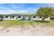 Well-maintained horse barn with a light-green roof, stalls, and a front porch area with seating at 6200 Adrian Pkwy., Conway, SC 29526