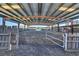 Covered horse arena featuring metal framing, fencing, and a dirt floor for equestrian activities at 6200 Adrian Pkwy., Conway, SC 29526