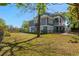 Spacious backyard with green grass, a black fence, and a charming two-story house with an American flag at 675 Wedgewood Dr., Murrells Inlet, SC 29576