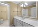 Bright bathroom featuring a single sink, a large mirror, and classic neutral-colored tile flooring at 675 Wedgewood Dr., Murrells Inlet, SC 29576