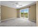 Bedroom with a balcony access, a ceiling fan and carpeting, provides a comfortable and relaxing retreat at 675 Wedgewood Dr., Murrells Inlet, SC 29576