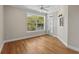 Light bedroom with an exterior balcony, large window, and hardwood floors throughout at 675 Wedgewood Dr., Murrells Inlet, SC 29576