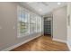 A bright bedroom with wood floors and a closet featuring built-in shelving for ample storage at 675 Wedgewood Dr., Murrells Inlet, SC 29576