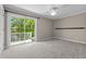 Bright bedroom with balcony access, a ceiling fan, and neutral-toned carpet that provides comfort and style at 675 Wedgewood Dr., Murrells Inlet, SC 29576