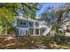 Charming two-story home with a screened porch, wooden staircase and a beautiful yard with mature shade trees at 675 Wedgewood Dr., Murrells Inlet, SC 29576