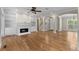 Spacious living room with hardwood floors, fireplace, and built-in shelving at 675 Wedgewood Dr., Murrells Inlet, SC 29576
