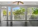 Relaxing screened-in porch features wood floors and panoramic views of the surrounding trees at 675 Wedgewood Dr., Murrells Inlet, SC 29576