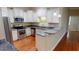 An open kitchen with white cabinets, stainless steel appliances, and granite countertops at 70 Mingo Dr. # 3-E, Pawleys Island, SC 29585