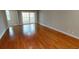 Living room with hardwood floors leading to a balcony with natural light at 70 Mingo Dr. # 3-E, Pawleys Island, SC 29585