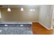An open concept living space with hardwood flooring, pendant lighting, and a kitchen bar at 70 Mingo Dr. # 3-E, Pawleys Island, SC 29585