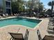 Community pool with lounge chairs and umbrellas at 70 Mingo Dr. # 3-E, Pawleys Island, SC 29585