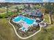 Aerial view of a community pool and clubhouse area with seating and landscaping at 7005 Grant St., Little River, SC 29566