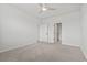 Bedroom with a ceiling fan, neutral carpeting, and two doors at 7005 Grant St., Little River, SC 29566