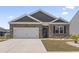 Traditional brick home with a two-car garage and a well-kept lawn at 7005 Grant St., Little River, SC 29566
