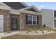 Charming brick home featuring a well-manicured front yard with decorative stone at 7005 Grant St., Little River, SC 29566