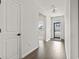 A bright hallway featuring hardwood floors and contrasting white doors, creating an inviting atmosphere at 7005 Grant St., Little River, SC 29566