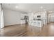 Modern kitchen with an island, white cabinets, stainless steel appliances, and hardwood floors at 7005 Grant St., Little River, SC 29566
