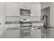 Kitchen with gray and white patterned granite countertops and stainless steel appliances at 7005 Grant St., Little River, SC 29566