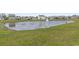 A tranquil pond surrounded by lush grass in a residential neighborhood at 7005 Grant St., Little River, SC 29566