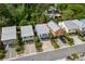 Brightly colored homes featuring metal roofs, driveways, and tropical landscaping in a verdant neighborhood at 77 Weatherboard Ct., Pawleys Island, SC 29585