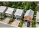 Colorful coastal homes with metal roofs, private driveways, and lush landscaping in a serene setting at 77 Weatherboard Ct., Pawleys Island, SC 29585