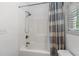 Clean bathroom showcasing a shower-tub combination with a white shower curtain at 77 Weatherboard Ct., Pawleys Island, SC 29585