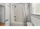 Bathroom with a bathtub, shower and gray striped curtain at 77 Weatherboard Ct., Pawleys Island, SC 29585