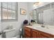 Bright bathroom featuring wooden vanity with white countertop and natural light from window at 77 Weatherboard Ct., Pawleys Island, SC 29585