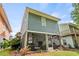 Rear exterior view showcasing the screened porch and outdoor living space at 77 Weatherboard Ct., Pawleys Island, SC 29585
