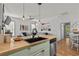 Open kitchen view with breakfast bar overlooking the living room and dining area with wood floors at 77 Weatherboard Ct., Pawleys Island, SC 29585
