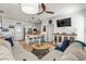 Open-concept living room featuring a comfortable sofa, ceiling fan, and kitchen view at 77 Weatherboard Ct., Pawleys Island, SC 29585
