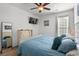 Bright main bedroom featuring a large window, ceiling fan and comfortable bed with lots of pillows at 77 Weatherboard Ct., Pawleys Island, SC 29585