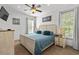Tranquil main bedroom with a ceiling fan, two windows, and a comfortable bed with a blue comforter at 77 Weatherboard Ct., Pawleys Island, SC 29585