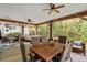 Relaxing covered patio offers wood beams, ceiling fans, dining, and cozy seating areas at 77 Weatherboard Ct., Pawleys Island, SC 29585