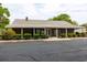Community brick building with a metal roof, American flag and well-maintained landscaping at 835 South Marlin Circle, Murrells Inlet, SC 29576