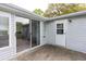 Exterior of home showcasing a sliding glass door, white siding, and small patio at 835 South Marlin Circle, Murrells Inlet, SC 29576
