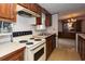 Functional kitchen with retro appliances, wood cabinets, and a view into the living area at 835 South Marlin Circle, Murrells Inlet, SC 29576