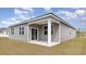 Covered back porch featuring white columns perfect for outdoor relaxation and overlooking the backyard at 882 Farmers Passage Loop, Loris, SC 29569