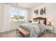 Bright bedroom featuring a cozy bed with a wicker headboard, natural light, and stylish furnishings at 882 Farmers Passage Loop, Loris, SC 29569