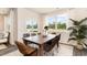 Dining room features a wooden table with seating for six, views to the outdoors, and bright natural light at 882 Farmers Passage Loop, Loris, SC 29569
