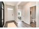 Bright entryway with wood-look floors, leading to bedroom and bathroom views, and white front door at 882 Farmers Passage Loop, Loris, SC 29569